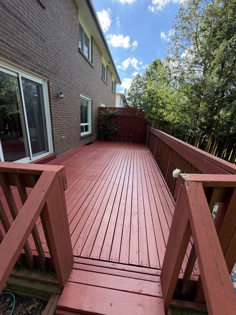 Freshly red-stained backyard deck after TrueCoat Painting service