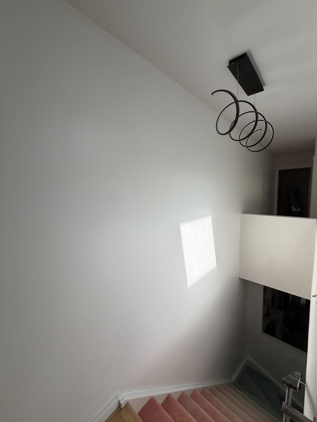 Freshly painted light grey stairwell wall after TrueCoat Painting service