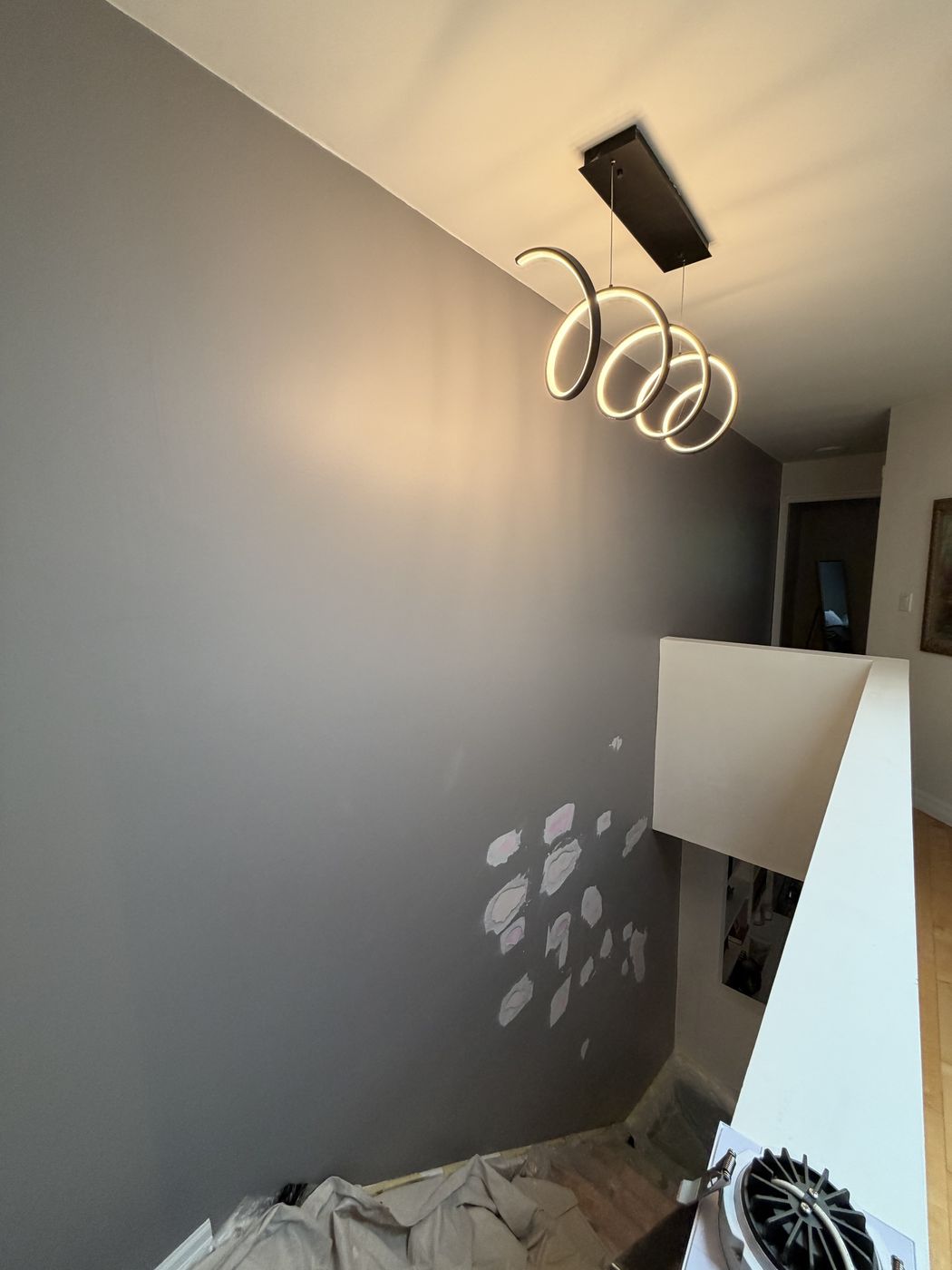 Stairwell accent wall with patched drywall before painting by TrueCoat Painting in Brampton