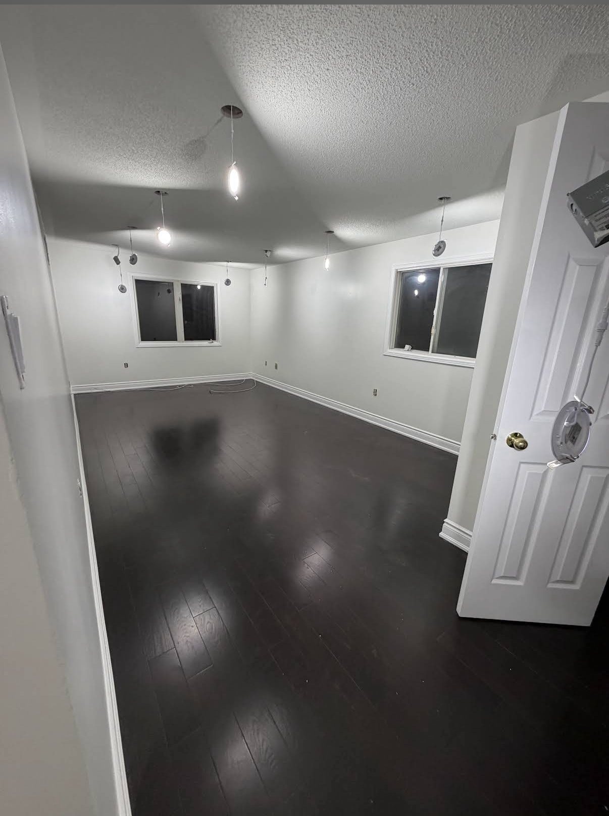 Freshly painted basement room with bright white walls and trim by TrueCoat Painting
