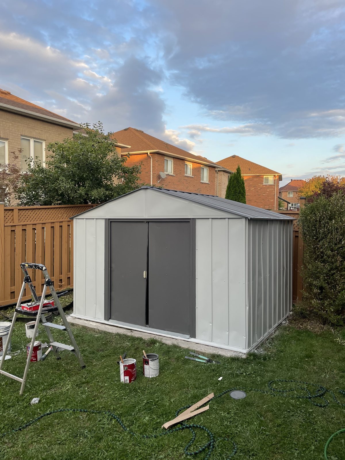 Freshly painted grey backyard storage shed by TrueCoat Painting in Brampton